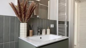 a bathroom with a white sink and a mirror at Soffio del Mar in Pila +48 photos