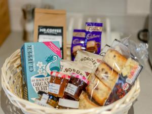 a basket filled with food and other snacks at Bluebell Lodge-Uk32958 in Molash