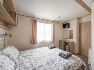 a bedroom with a bed and a window at Hallcroft Fishery in Retford