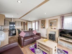 a living room with a couch and a table at Hallcroft Fishery in Retford