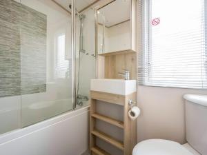 a bathroom with a sink and a toilet and a shower at Hallcroft Fishery in Retford