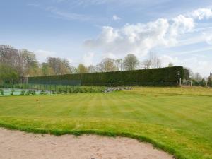 a large grass field with people in the distance at Grieve's Cottage - Uk11107 in Montrose