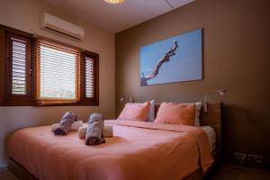 a bedroom with a large bed with stuffed animals on it at Luxury Ocean View Apartment, Private Beach, Infinity Pool, near Jan Thiel C3 in Willemstad +61 photos