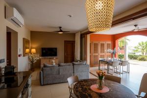 a living room with a couch and a table at Luxury Ocean View Apartment, Private Beach, Infinity Pool, near Jan Thiel C3 in Willemstad