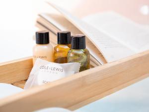 three bottles of essential oils in a wooden drawer at Owls Rest - Iua in Cayton