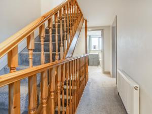 a staircase with wooden railings in a house at Owls Rest - Iua in Cayton