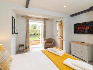 a bedroom with a bed and a window at Dovecote House-Uk30233 in Cayton