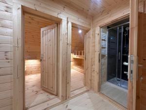 a wooden sauna with wooden walls and a door at POD mit Bad 84 in Hüde