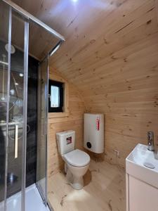a wooden bathroom with a toilet and a shower at POD mit Bad 84 in Hüde