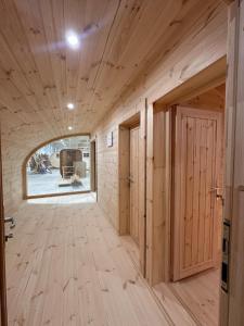 a room with wooden walls and a hallway with two doors at POD mit Bad 84 in Hüde +5 photos