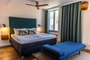 a bedroom with a bed and a large window at Motel One Copenhagen in Copenhagen