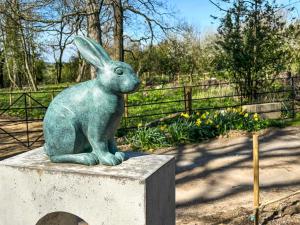 a statue of a rabbit sitting on a concrete block at Gardeners Cottage - Uk51831 in Great Ayton