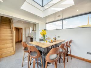 a kitchen with a large wooden table and chairs at Blodfryn in Llandudno Junction