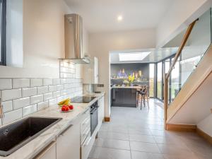 a kitchen with a sink and a counter top at Blodfryn in Llandudno Junction +20 photos