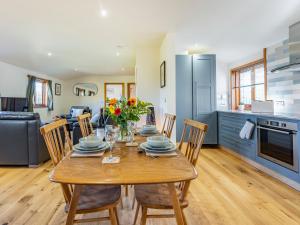 a kitchen and dining room with a table and chairs at Snowdrop Lodge -Uk32959 in Molash +25 photos
