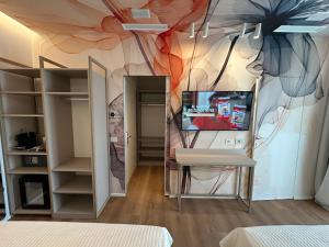 a room with a wall with a painting on it at Feel Good in Rimini