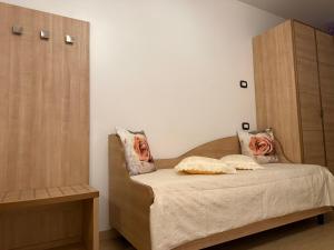 a bedroom with a bed and a wooden cabinet at Le Essenze - Agriturismo con vista in Cesena