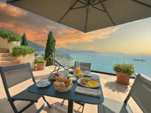 a table with food on it with a view of the ocean at Mira Suite in Vietri sul Mare