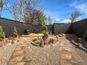 a garden with a bench and a fence at West Mains Barn - Uk51957 in Kilbirnie