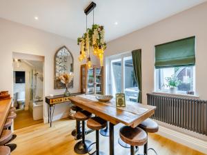 a dining room with a wooden table and stools at Jorvik Villas in York