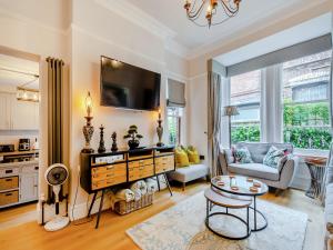 a living room with a couch and a tv at Jorvik Villas in York