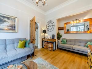a living room with two couches and a table at Jorvik Villas in York +27 photos