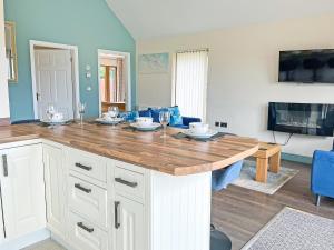 a kitchen with a large wooden island in a room at Jasmine Lodge in Garton
