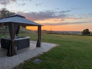 a gazebo with an umbrella in a field at Le Essenze - Agriturismo con vista in Cesena