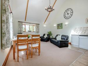 a kitchen and living room with a table and chairs at Hayloft - Uk49909 in Blandford Forum