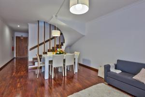a dining room and living room with a table and chairs at Golden Place Apartment in Funchal