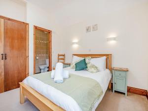 a bedroom with a large bed with a wooden headboard at Hayloft - Uk49909 in Blandford Forum +35 photos