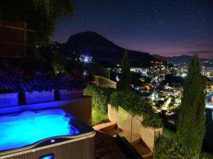 a hot tub on the roof of a house at night at Mira Suite in Vietri sul Mare