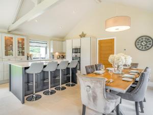 a kitchen and dining room with a wooden table and chairs at Uk34190 - Gowan View in Arkholme