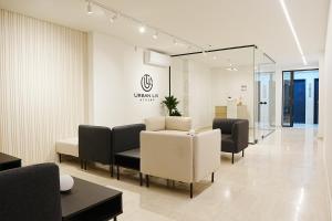 a lobby with a waiting room with couches and chairs at Urban Liv Athens in Athens