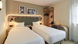 a hotel room with two beds and a window at Campanile PRIME - Paris - Porte de Bagnolet in Bagnolet +24 photos
