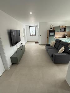 a living room with a couch and a tv at Ferienwelt Wittenberge in Wittenberge