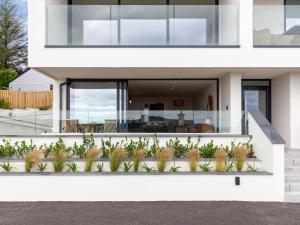 a white house with plants in front of it at Chi An Mor in Charlestown