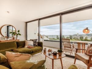 a living room with a couch and a large window at Chi An Mor in Charlestown