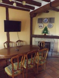 a dining room with a table and chairs and a fireplace at La Fragua de los Alvaro in Turégano