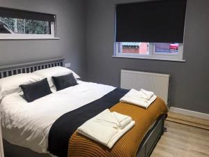 a bedroom with a bed with towels on it at The Bunker in Otterburn