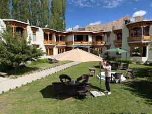 a man standing in front of a large building at Mandalchan hotel in Leh +59 photos