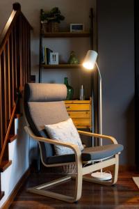 a rocking chair in a living room with a lamp at CAN ROC in Camprodon