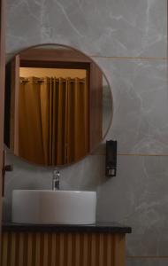 a bathroom with a sink and a mirror at 4 Seasons Residency in Katra