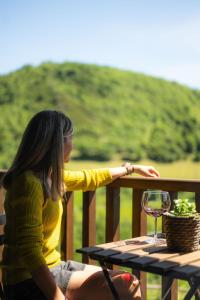 a woman sitting at a table with a glass of wine at CAN ROC in Camprodon +25 photos