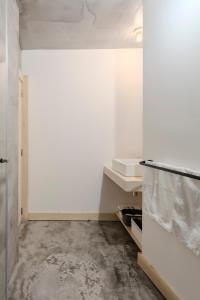 a bathroom with white walls and a white door at LOVELY Central Apartment 3Bdr by Vinum Apartment 1890 in Coimbra