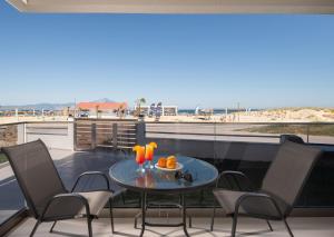 a table on a balcony with a view of the beach at Hotel Sarti Beach in Sarti