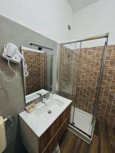 a bathroom with a sink and a shower at HOTEL CONCORDIA in Montecatini Terme +39 photos