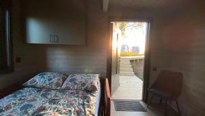 a bedroom with a bed and a door with a window at Hjertero - Hide Away Suite in Sortland