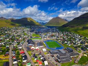 an aerial view of a parking lot in a mountain at Rogvi's new appartment in Klaksvík
