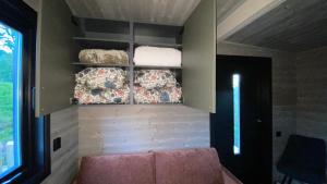 a living room with a couch and some towels at Hjertero - Hide Away Suite in Sortland